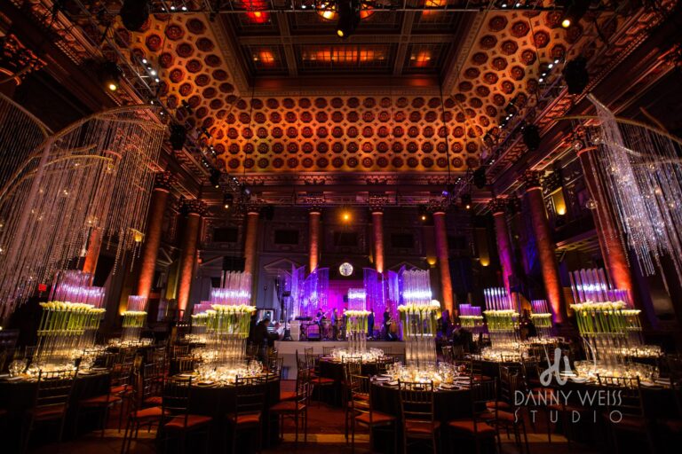 Wedding reception NYC with florals, table settings, and guests dining